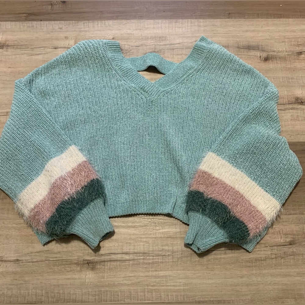 Cozy oversized light blue sweater with fuzzy detailing on sleeves.